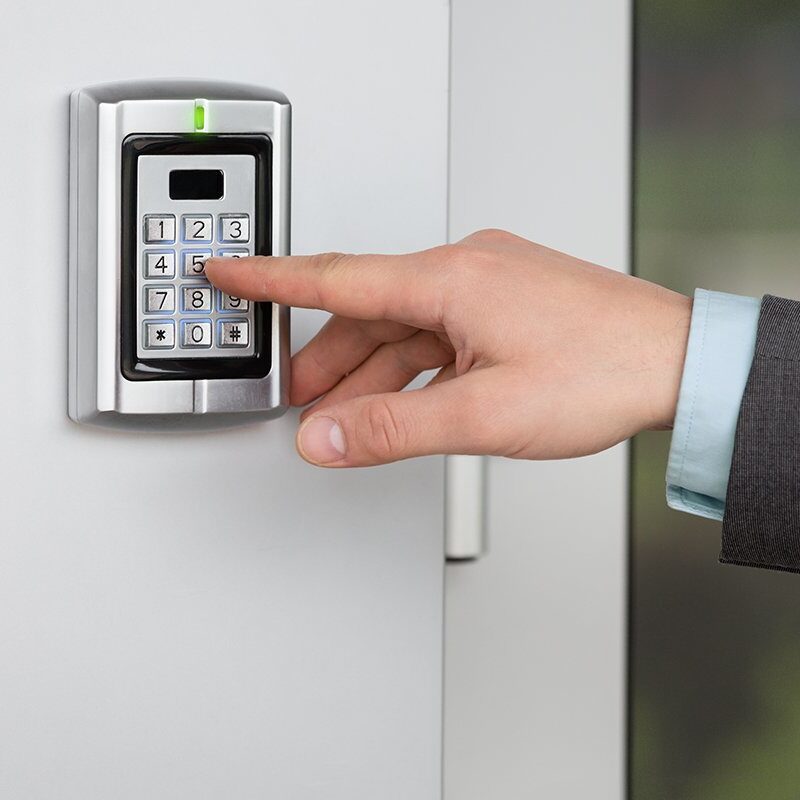 Close up of businessman hand entering security system code Human hand pressing the security code combination to unlock the door