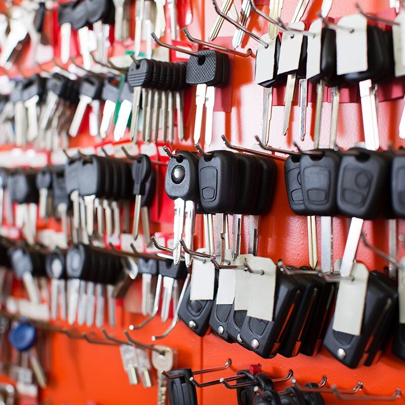 Locksmith stand with car keys on hooks Locksmith stand with variety of car and van keys on hooks